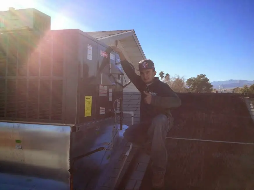HVAC technician performing HVAC Inspection on a rooftop unit in Timberwood Park